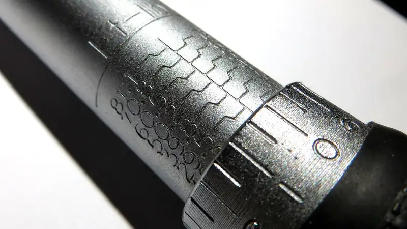 Close-up of the engraved scale and locking collar on a silver torque wrench handle.